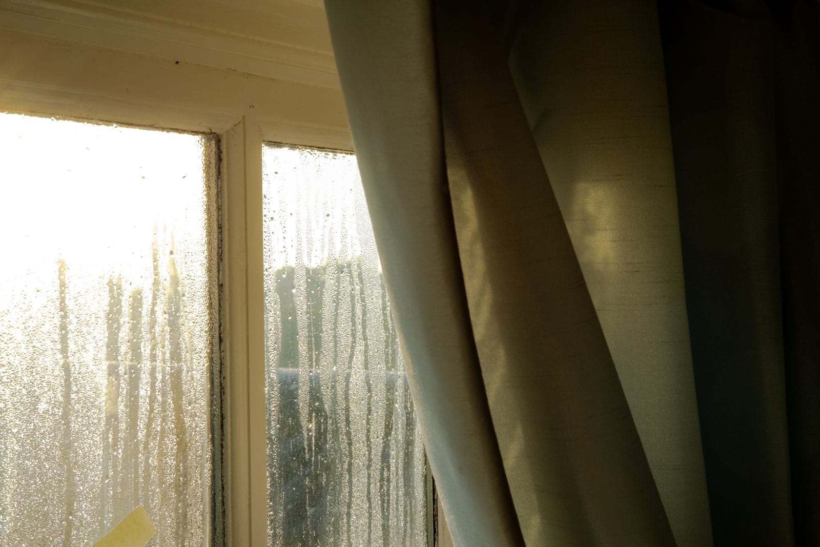 Early morning showing heavy condensation on a bedroom window in early winter, which may cause health issues to vulnerable people. Condensation on window